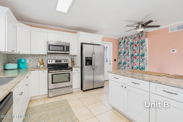 kitchen featuring white cabinetry, crown molding, tasteful backsplash, and appliances with stainless steel finishes