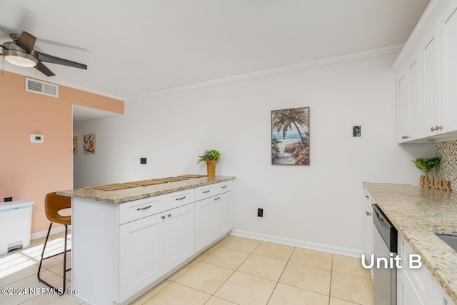 kitchen featuring light stone counters, a kitchen breakfast bar, dishwasher, and white cabinets