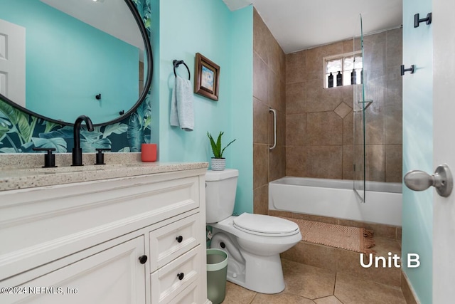 full bathroom with vanity, tiled shower / bath, tile patterned flooring, and toilet