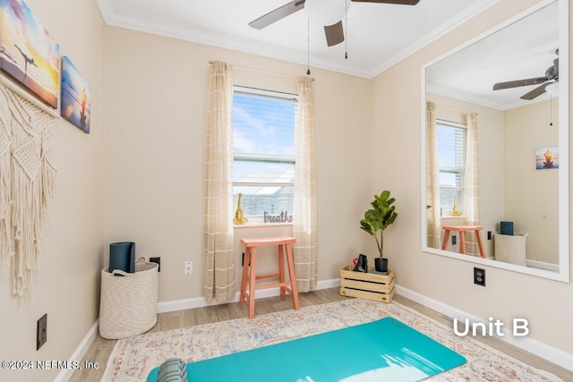 sitting room with ceiling fan, ornamental molding, and hardwood / wood-style floors