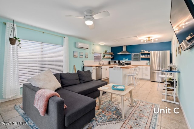 living room featuring light tile patterned flooring, a wall mounted AC, and ceiling fan