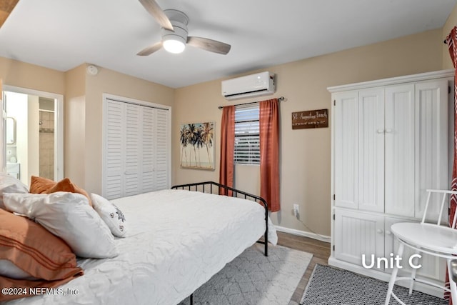 bedroom with ceiling fan, wood-type flooring, a closet, and a wall mounted AC