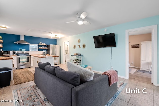 tiled living room featuring ceiling fan