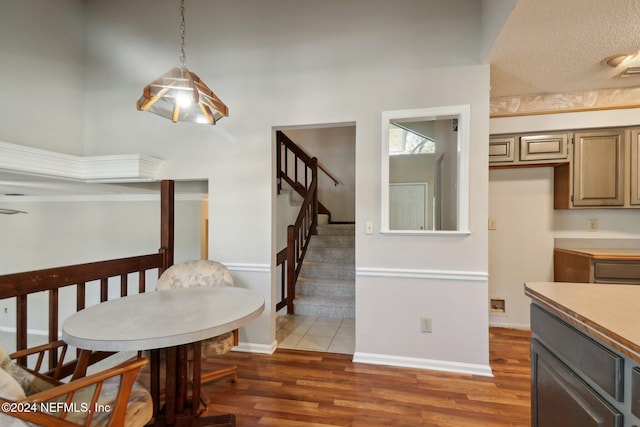 dining area featuring dark hardwood / wood-style flooring and a high ceiling