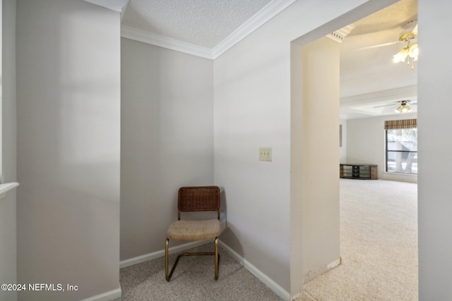 living area featuring ceiling fan, a textured ceiling, carpet floors, and crown molding