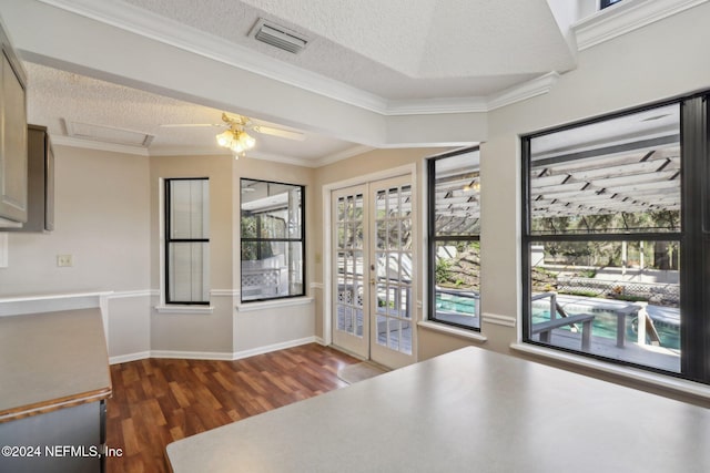 kitchen featuring dark wood-type flooring, ceiling fan, a textured ceiling, and ornamental molding