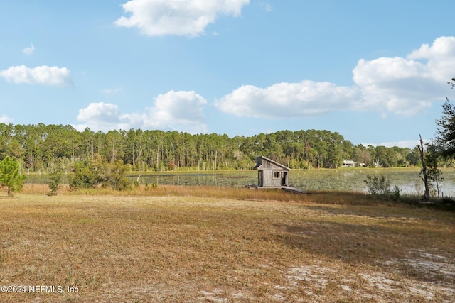 view of yard with a rural view and a water view