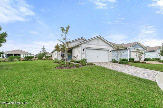 single story home featuring a garage and a front lawn