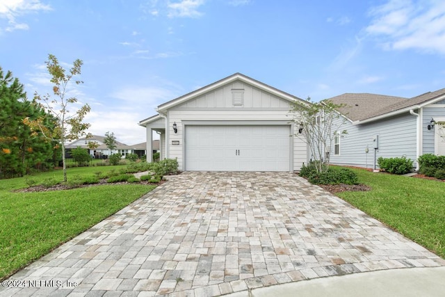 single story home featuring a front lawn and a garage