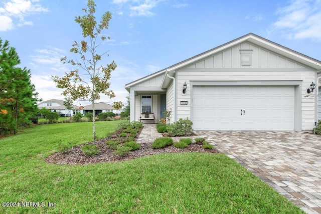 view of front of home with a garage and a front lawn