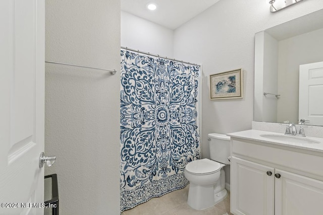 bathroom featuring toilet, vanity, and tile patterned floors