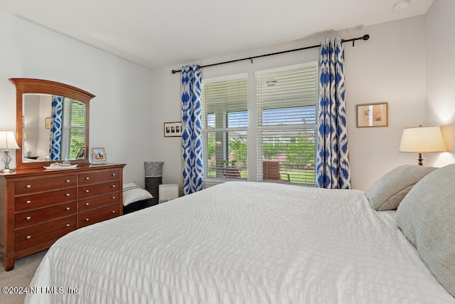 bedroom featuring light colored carpet