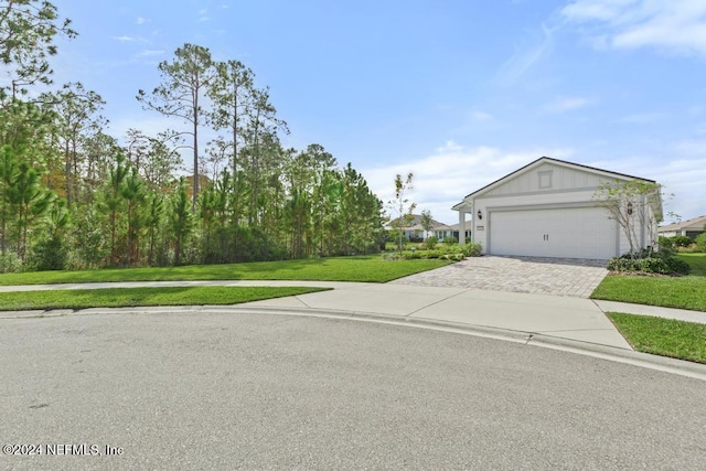 view of front of property with a garage and a front lawn