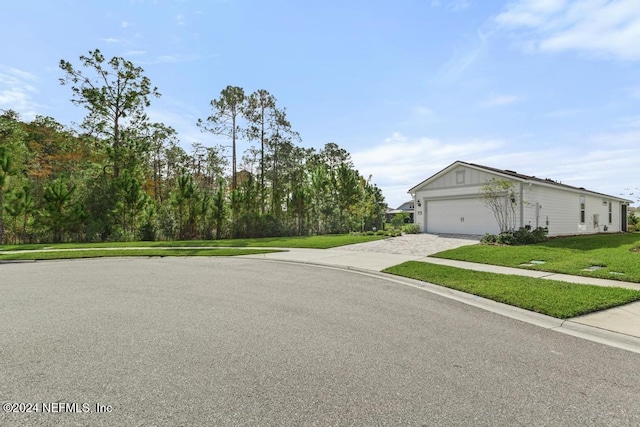 view of front of home with a garage and a front yard