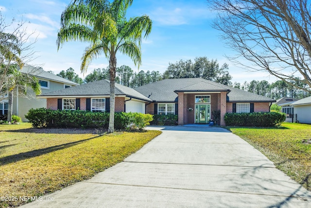 ranch-style home with a garage and a front yard