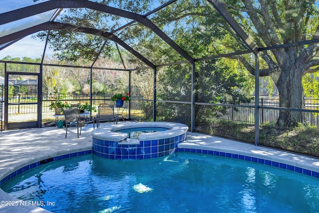 view of swimming pool featuring an in ground hot tub, a lanai, and a patio