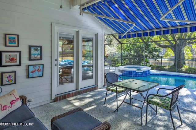 view of patio with a lanai and an in ground hot tub