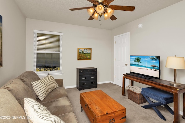 living room featuring carpet flooring, a textured ceiling, and ceiling fan