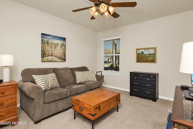 carpeted living room with ceiling fan