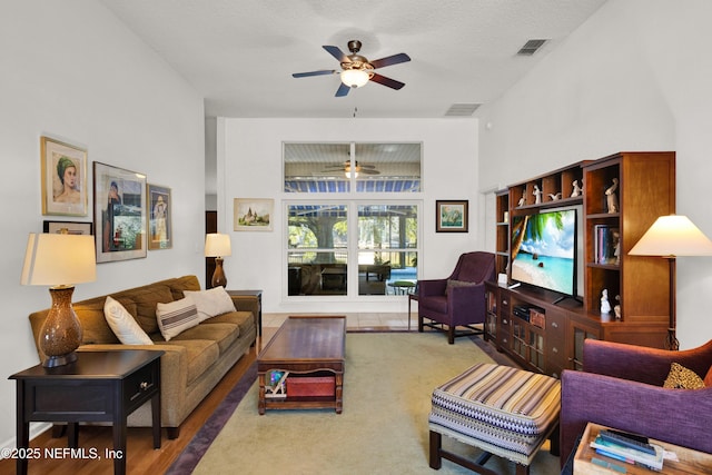 carpeted living room featuring ceiling fan