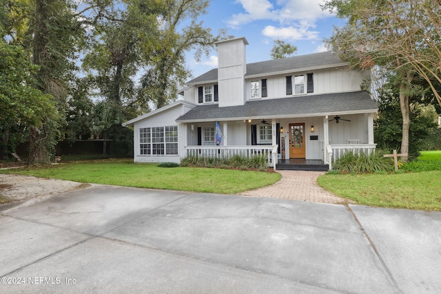 view of front of house with covered porch and a front yard