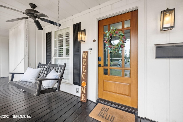 doorway to property with ceiling fan and covered porch