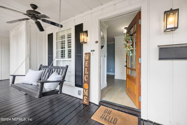 view of exterior entry featuring ceiling fan