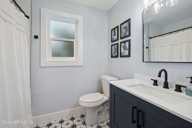 bathroom featuring tile patterned flooring, vanity, and toilet