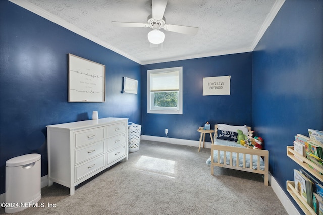 bedroom featuring a textured ceiling, light colored carpet, ceiling fan, and ornamental molding