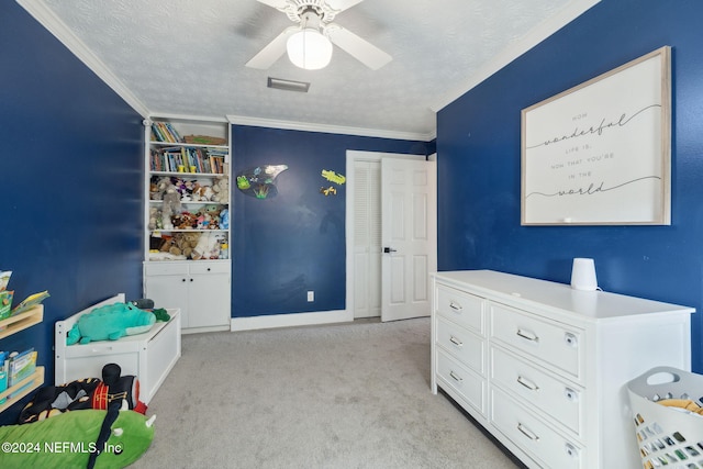 bedroom featuring ceiling fan, crown molding, and a textured ceiling