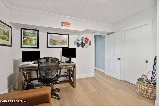 office with light hardwood / wood-style flooring, a textured ceiling, and ornamental molding