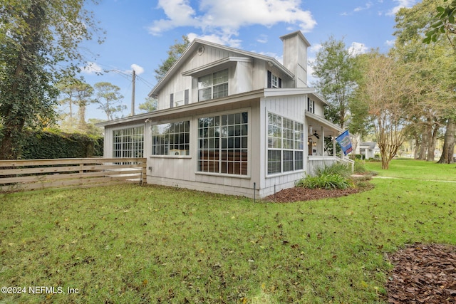 rear view of property with a lawn