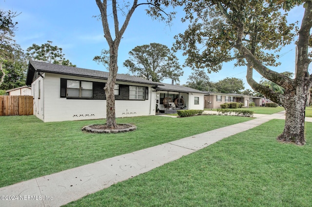 ranch-style home with a front lawn