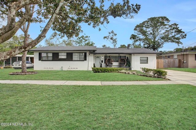 ranch-style house with a front lawn