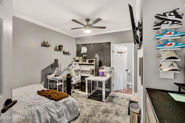 bedroom featuring hardwood / wood-style floors, ceiling fan, and crown molding