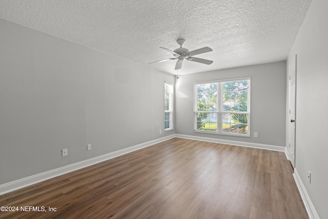 spare room featuring hardwood / wood-style floors, a textured ceiling, and ceiling fan