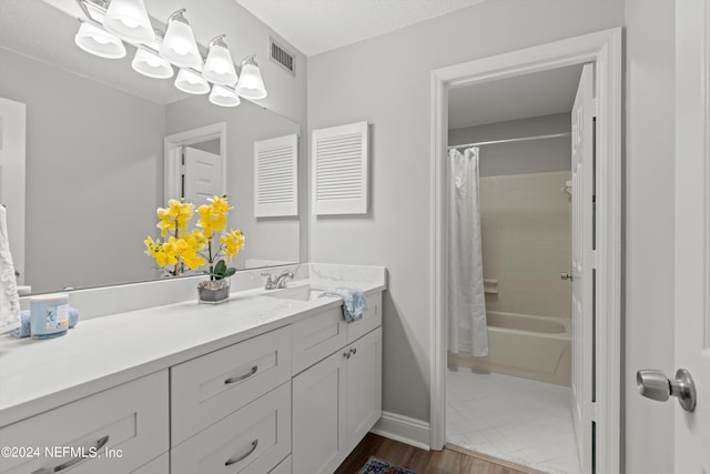 bathroom with shower / bath combination with curtain, vanity, and wood-type flooring