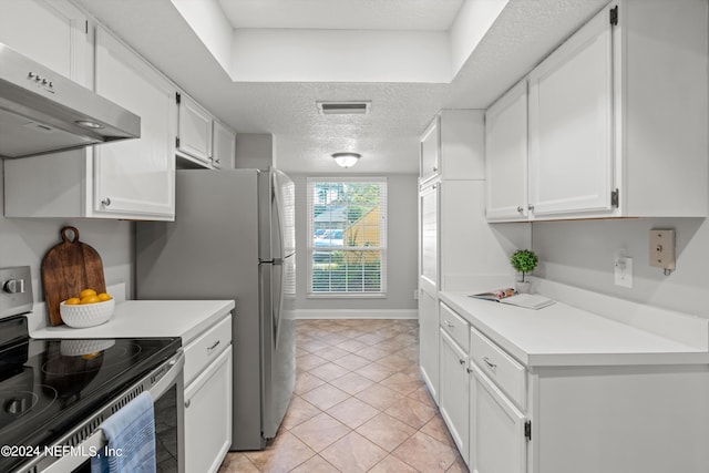 kitchen with stainless steel range with electric stovetop, white cabinets, light tile patterned floors, a textured ceiling, and range hood