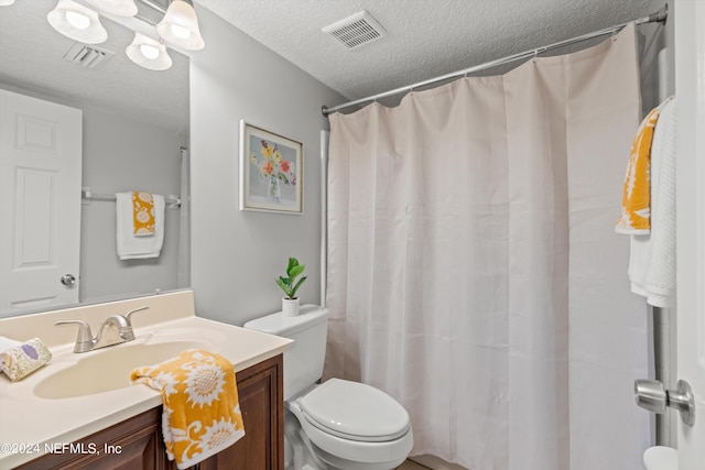 bathroom with a shower with shower curtain, vanity, toilet, and a textured ceiling