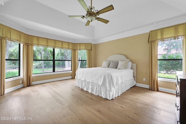 bedroom with ornamental molding, a textured ceiling, ceiling fan, light hardwood / wood-style flooring, and lofted ceiling