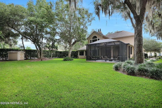 view of yard featuring glass enclosure, a patio area, and a shed