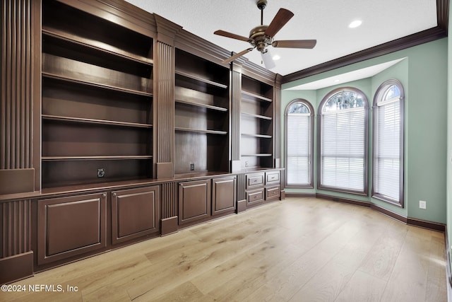 unfurnished living room featuring crown molding, ceiling fan, light hardwood / wood-style floors, and a textured ceiling