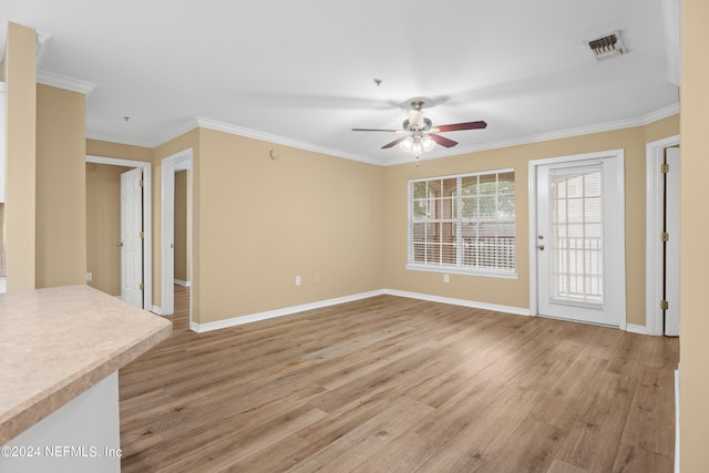 unfurnished living room featuring light hardwood / wood-style floors, ceiling fan, and ornamental molding