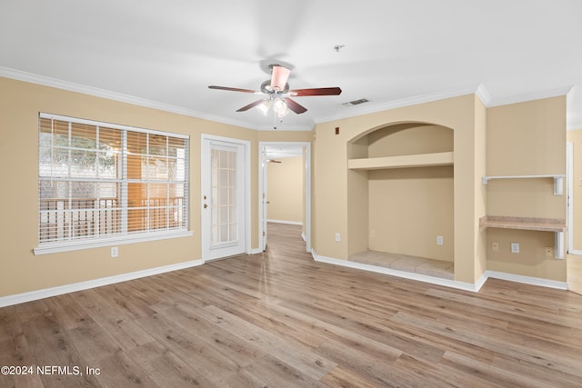 spare room with light hardwood / wood-style floors, ceiling fan, built in features, and ornamental molding