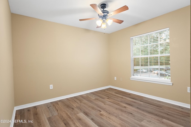 empty room with ceiling fan and light hardwood / wood-style floors