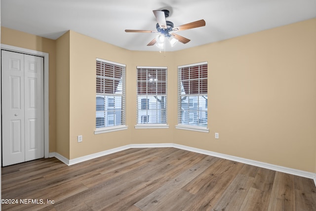 unfurnished room with wood-type flooring and ceiling fan