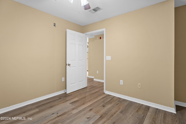 empty room featuring ceiling fan and light hardwood / wood-style flooring