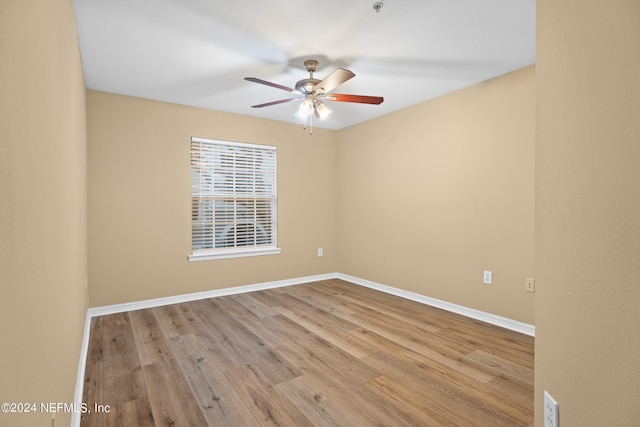 spare room with light hardwood / wood-style floors and ceiling fan