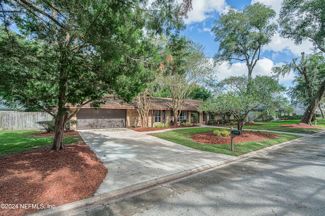 view of front of home featuring a garage and a front lawn