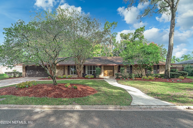 ranch-style home featuring a front yard and a garage